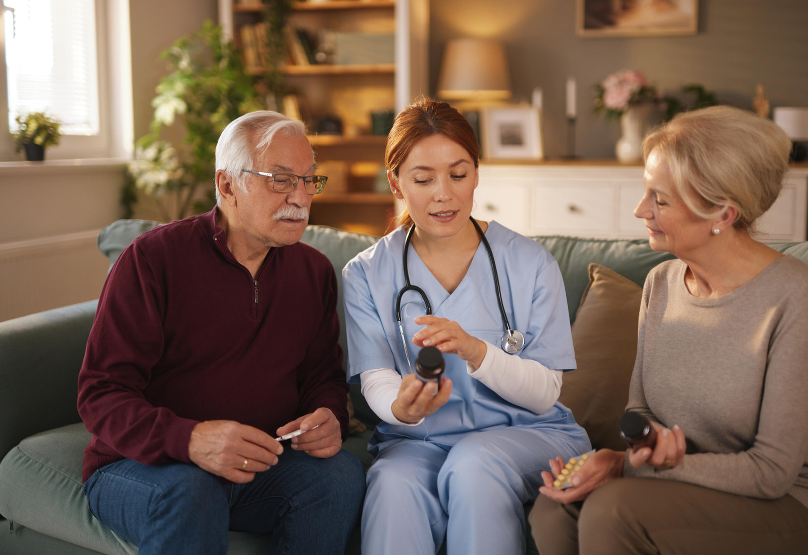 Advance Life nurse reviewing medication with an older couple at home