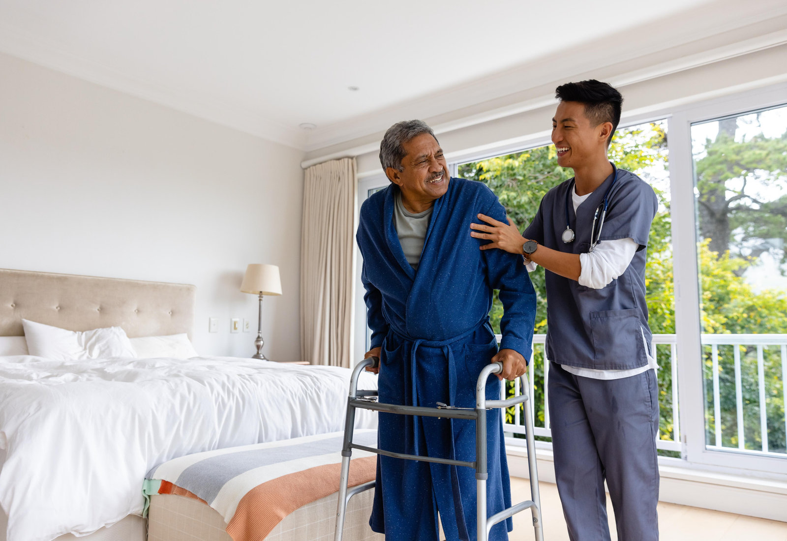 Nurse helping a client walk at home